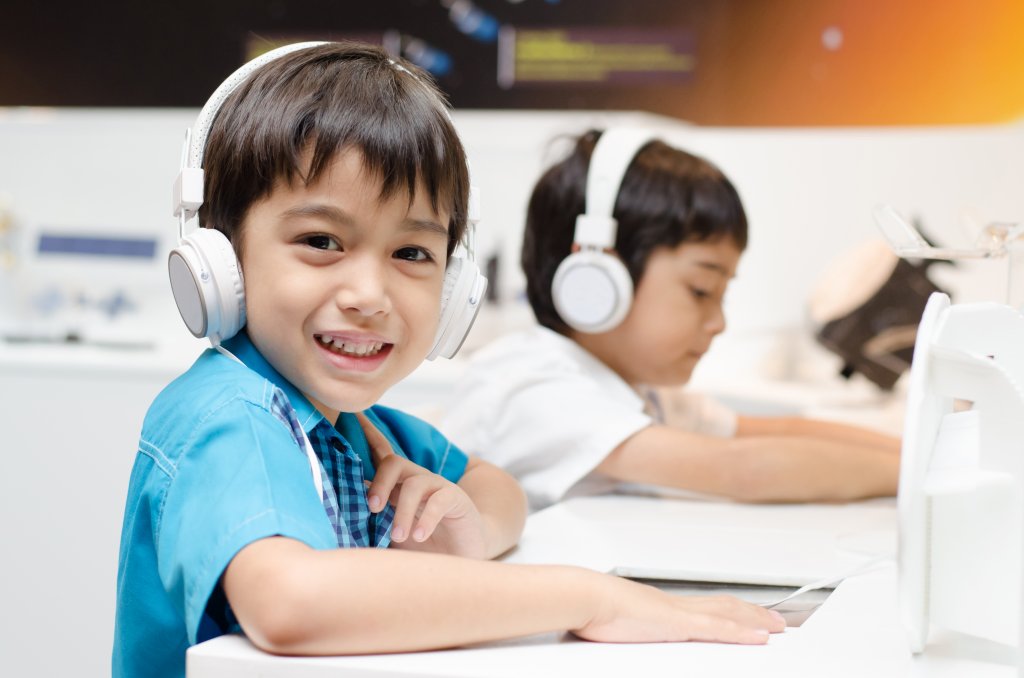 Elementary boy coding at computer
