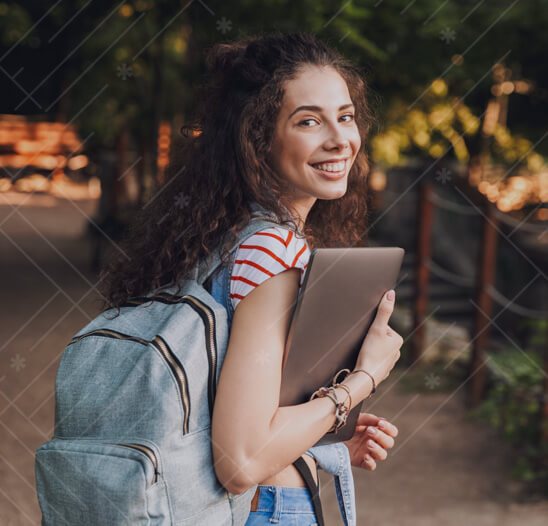 Teenage girl smiling with backpack