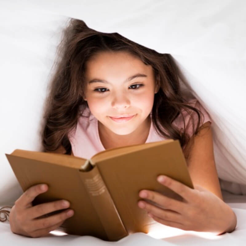 Young girl reading coding book