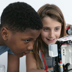 Two kids playing with robot