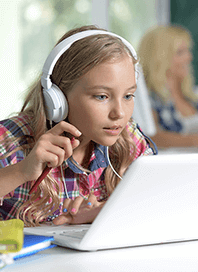Girl wearing headphones in coding class