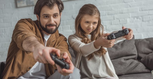 Java is used in game development, dad and daughter playing games