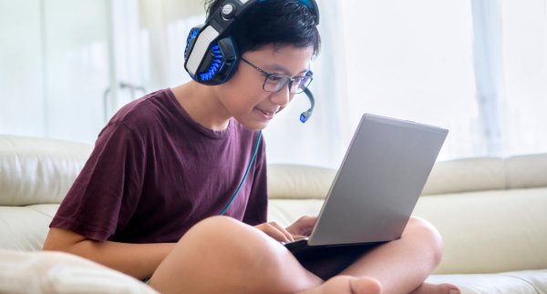 Boy on computer with headphones