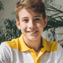 Male summer camp student in yellow collared shirt 