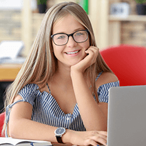 Girl with glasses taking coding classes in the summer