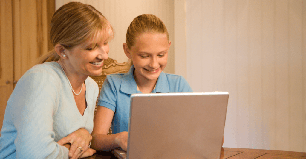 Mom with daughter using computer.