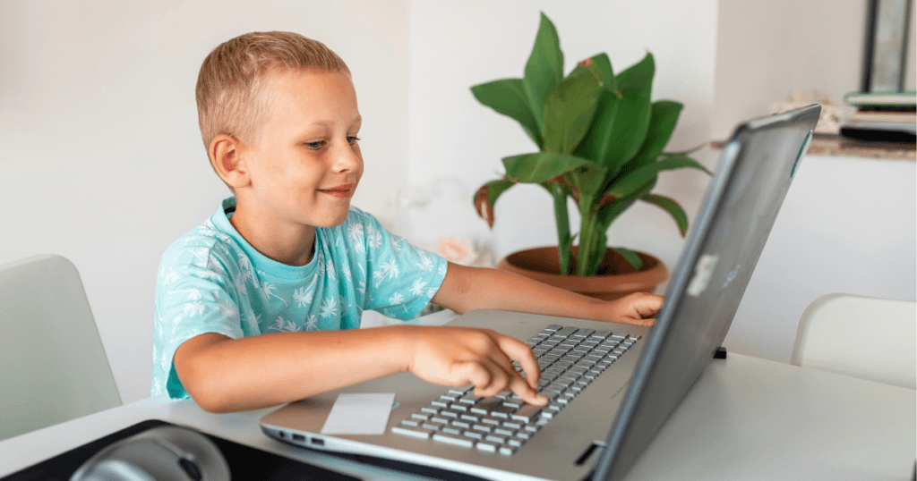 Boy coding with on laptop